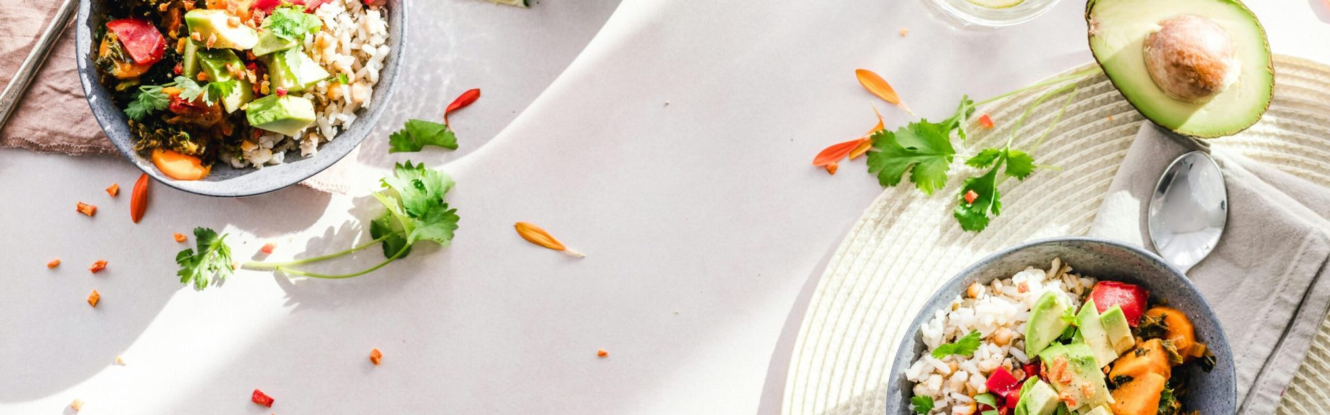 Top-down view of vibrant vegan bowls filled with fresh vegetables, perfect for a healthy meal.